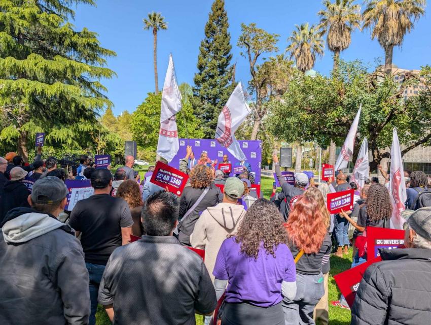 Assemblymember Buffy Wicks speaking with a crowd of hundreds of rideshare drivers, together celebrating the announcement of AB 1340