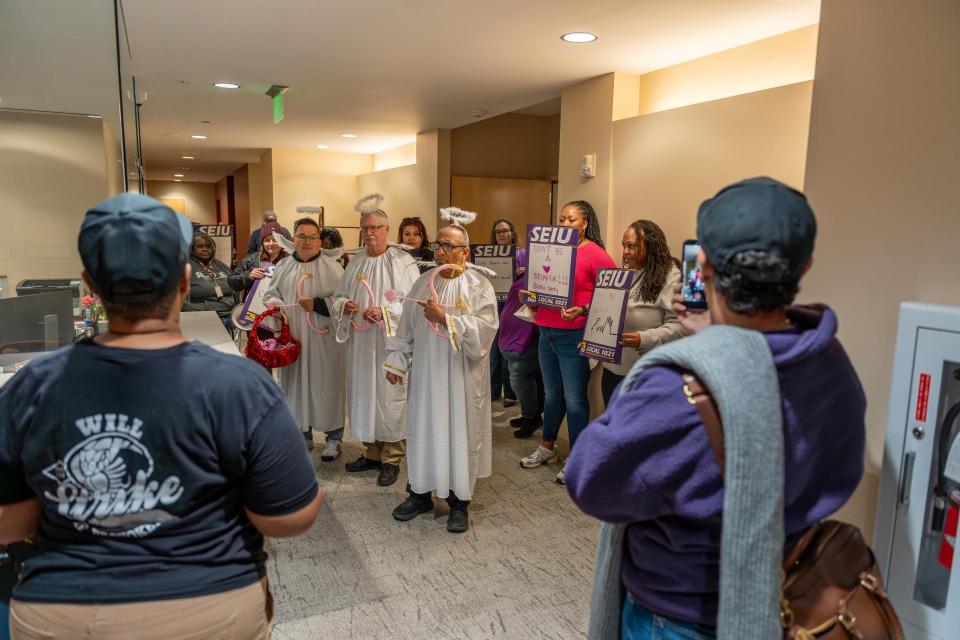 SEIU 1021 members dressed as cupids delivering Valentine's Day-themed petitions to the Solano County Board of Supervisors