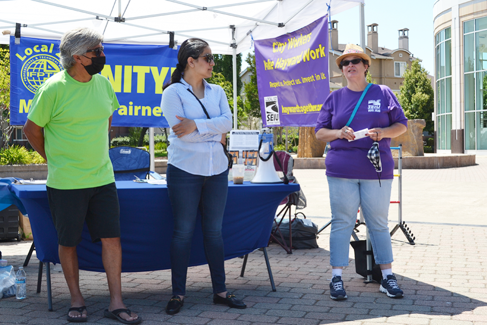 As HAME's Danny Magalhaes and City of Hayward City Councilmember and Mayor Pro Tempore  Aisha Wahab look on, SEIU 1021's Evelyn Olivera addresses the union coalition of HAME, IFPTE Local 21 and SEIU 1021 members.