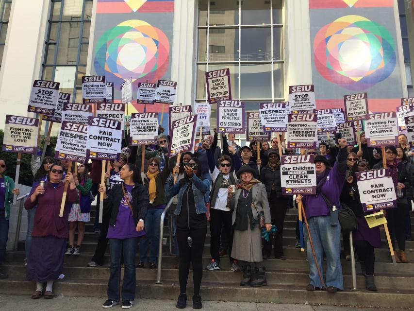City of Oakland Main Library workers picket and rally on the front steps of the library.