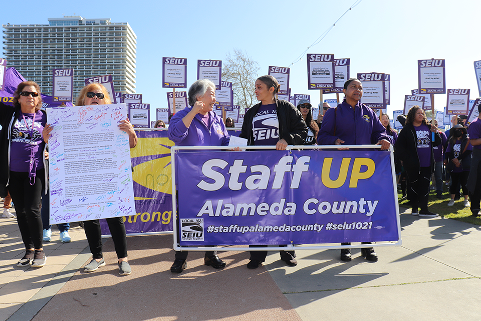 SEIU 1021 leaders march from Lake Merritt Amphitheater to 1221 Oak St. on February 13 with a letter demanding the Board of Supervisors Staff Up Alameda County. 